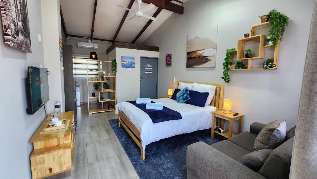 a bedroom with a bed and a living room with a couch at Blairgowrie Skyline in Johannesburg