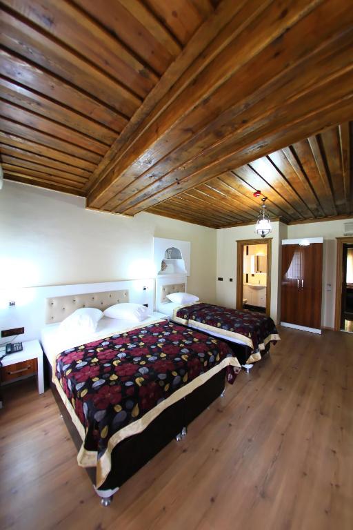Postel nebo postele na pokoji v ubytování Bacchus Pension