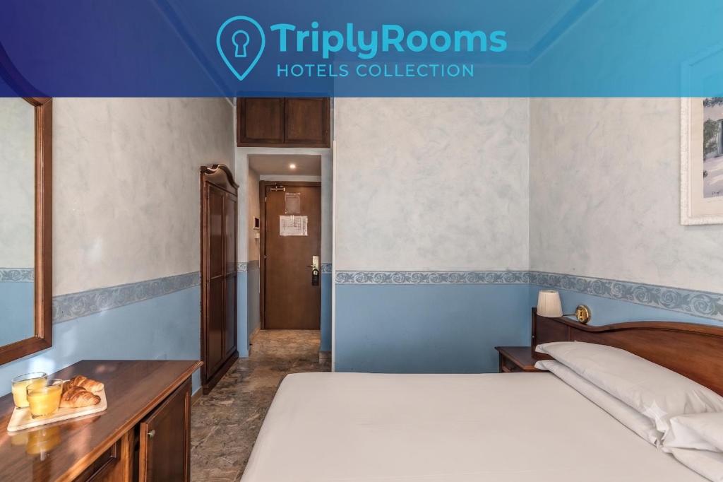 a hotel room with a bed and a desk at TriplyRooms Collection - Roma Colosseo in Rome