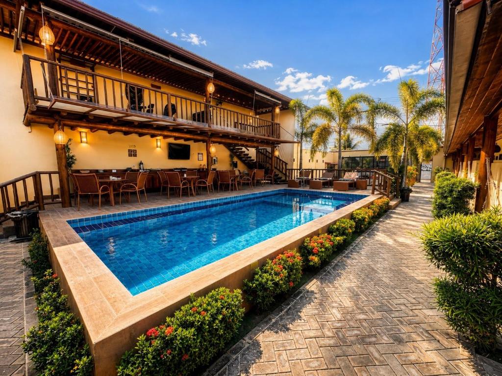 a swimming pool in the middle of a house at Pousada Lua Nova Charmosa Pipa in Pipa