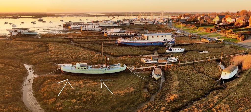 a group of boats docked in a harbor at Houseboat Zeldenrust in West Mersea
