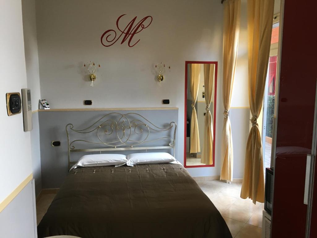 a bedroom with a large bed with a black blanket at Le Divine - Reception Via XXV Aprile 5 in Levanto