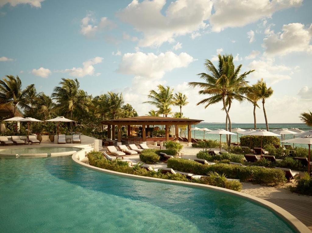 a resort with a swimming pool and a beach at Rosewood Mayakoba in Playa del Carmen