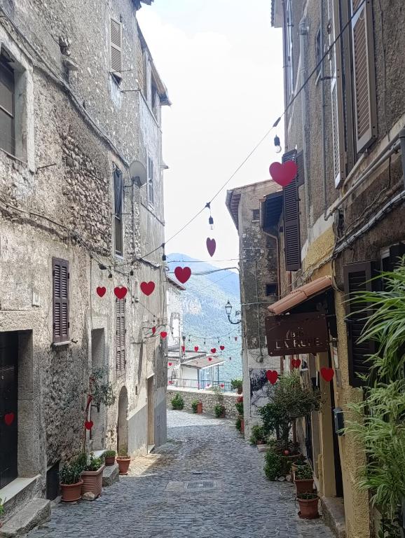 an alley with hearts hanging from buildings at B&B La Rupe in Norma