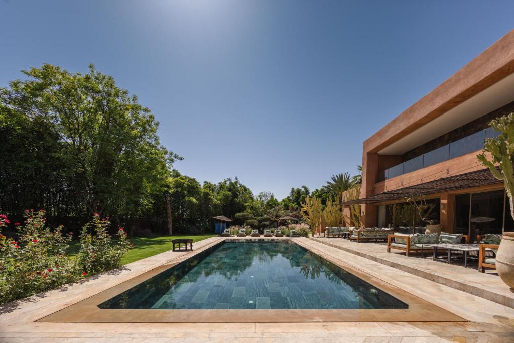 a swimming pool in the backyard of a house at PALAIS SOHAN in Marrakesh