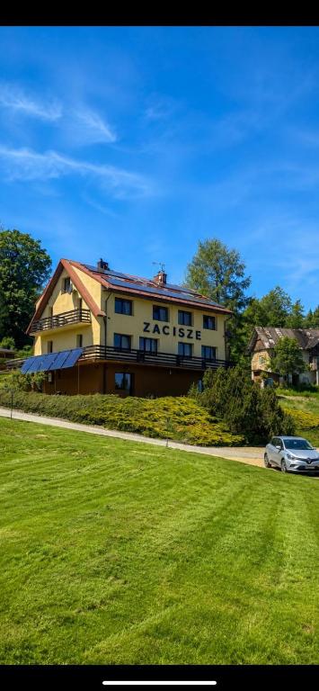 a house with a car parked in front of it at Zacisze in Zwardoń