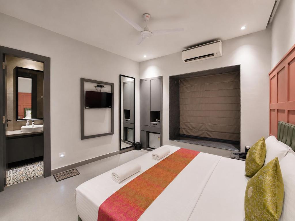 a bedroom with a large bed and a bathroom at The Bay Suites - Salt Lake in kolkata