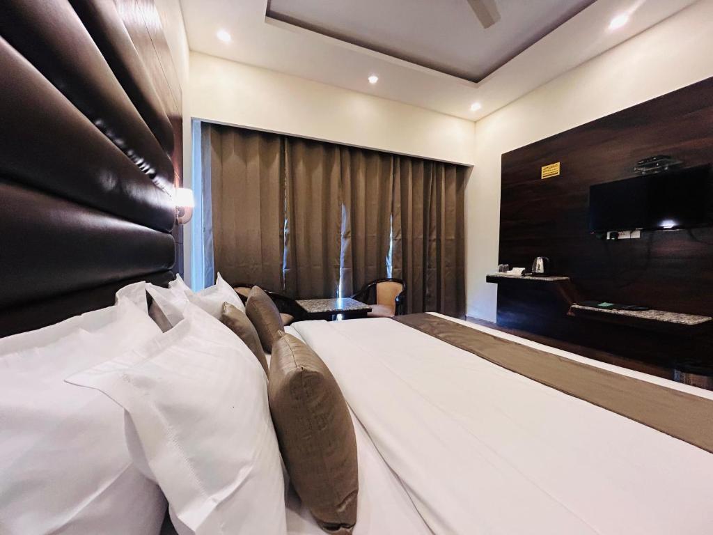 a bedroom with a large bed with a piano at Dool Resort in Mussoorie