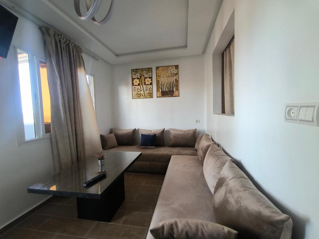 a living room with a couch and a table at Younes résidence 2 in Asilah