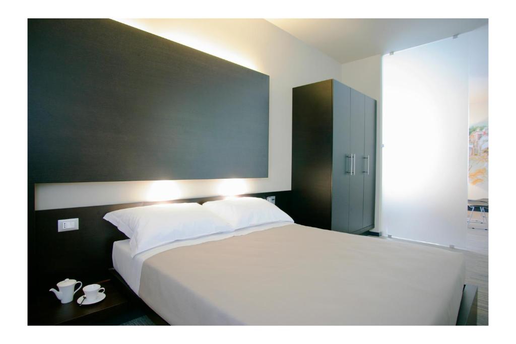 Postel nebo postele na pokoji v ubytování Art Hotel Udine
