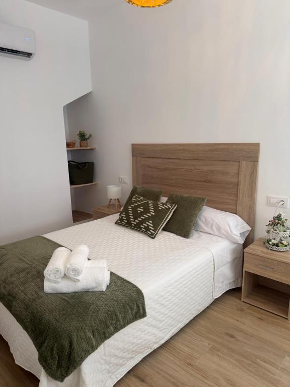 a bedroom with a bed with towels on it at Casa Boho in Puerto de Mazarrón