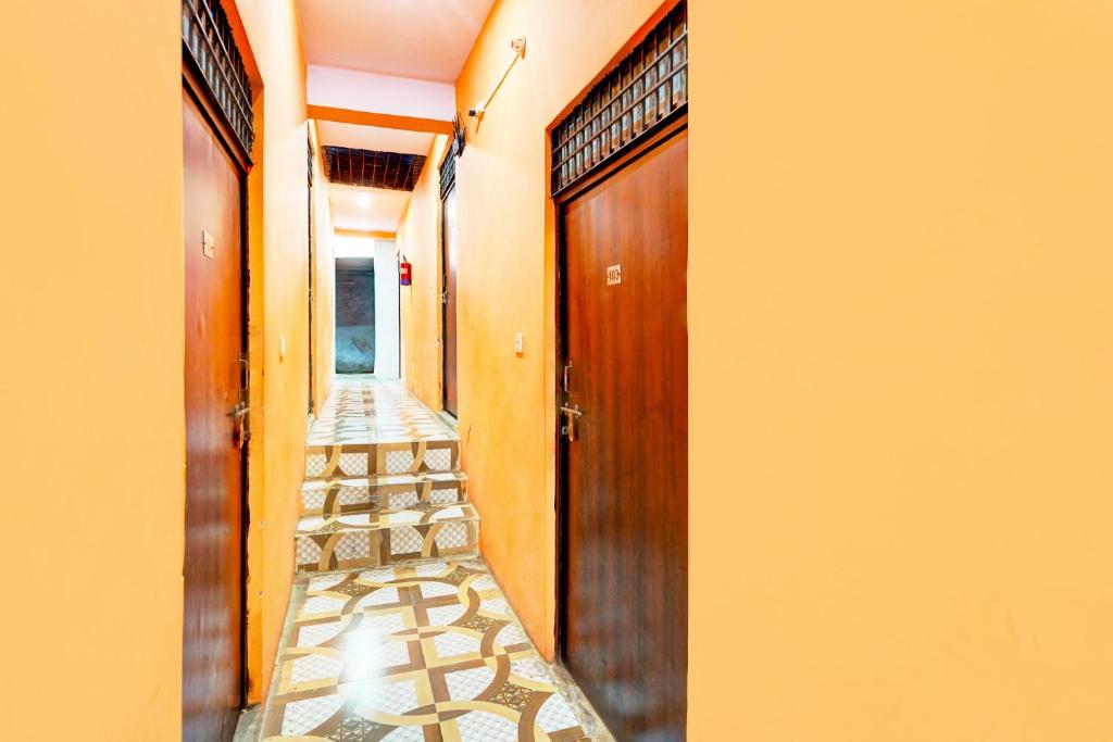 a corridor of a house with a door and a walkway at HOTEL O SUNSHINE in Ghaziabad