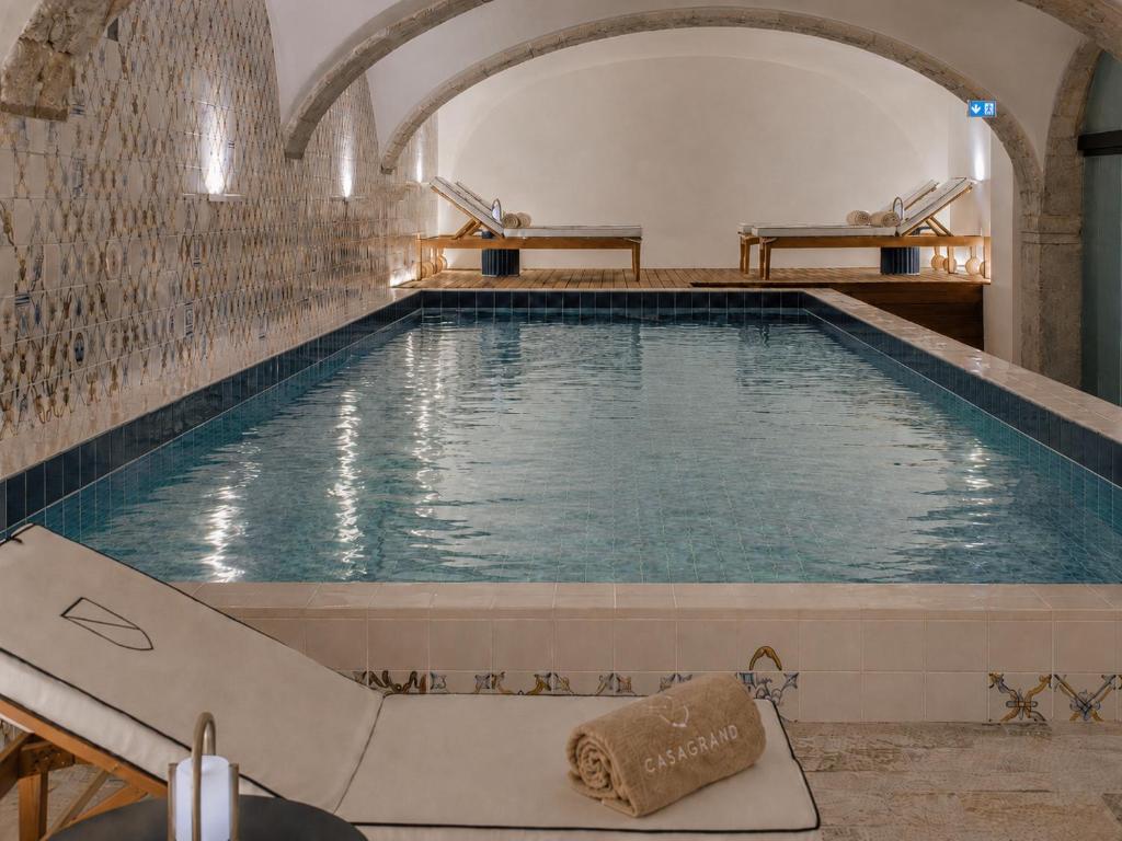 an indoor swimming pool with a large swimming pool at Casagrand Luxury Apartments Lisboa in Lisbon