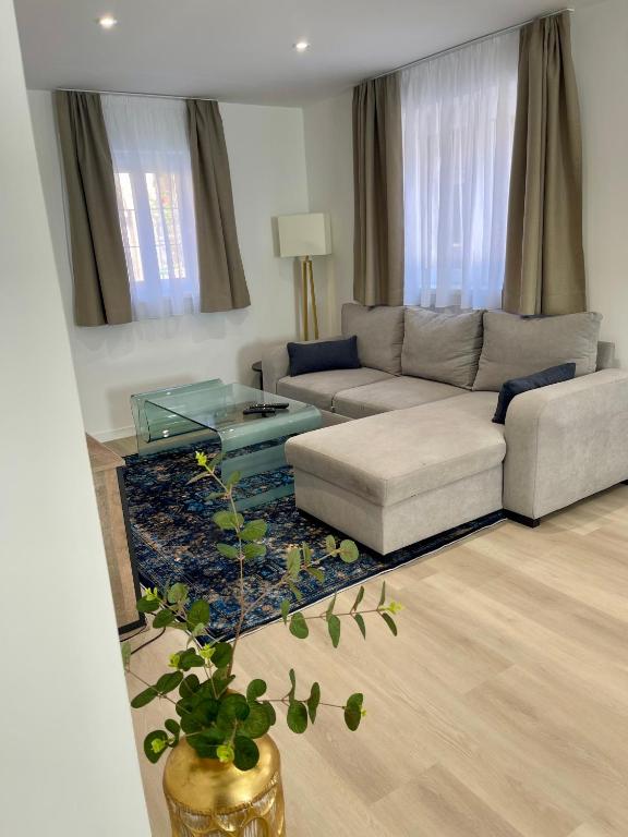 a living room with a couch and a table at La Maison Caroline in Surbourg