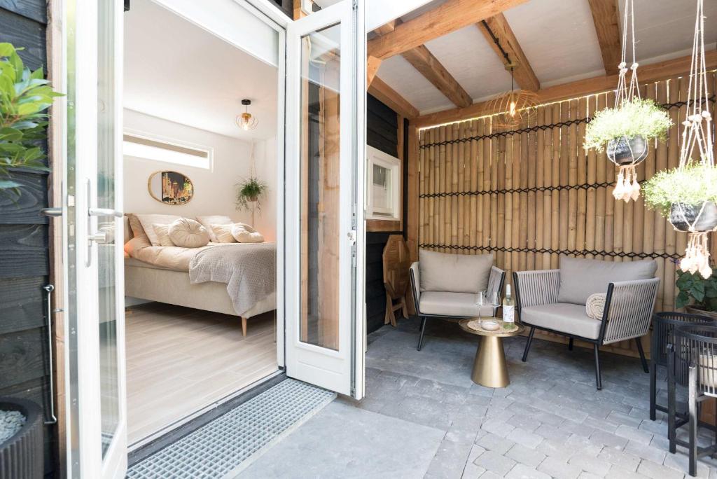 a room with a bed and a sliding glass door at Ben Thuis Studio Alkmaar in Alkmaar