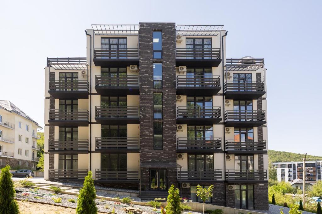 an apartment building with balconies on the side at MONTE GreeN in Polyana