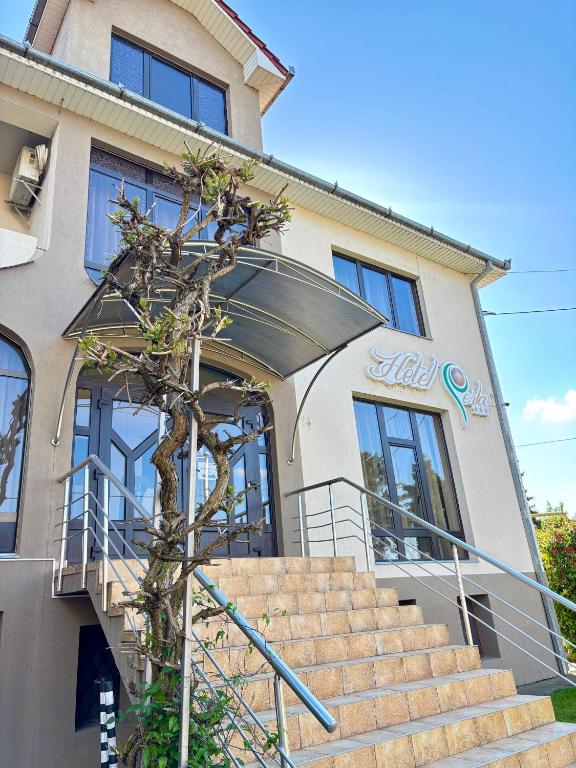 a building with stairs in front of it at Hotel Perla in Satu Mare