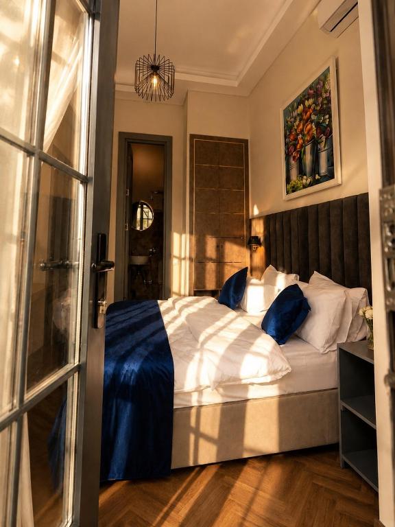 a bedroom with a large bed with a blue blanket at BS Studios in Baku