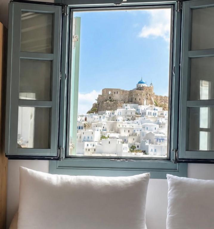 a window with a view of a castle at Arhontiko Houses in Astypalaia