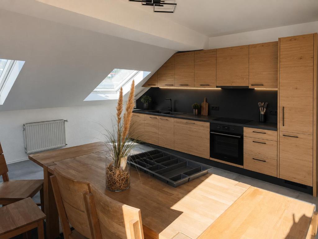 a kitchen with wooden cabinets and a wooden table at Im Weidig in Obernburg am Main