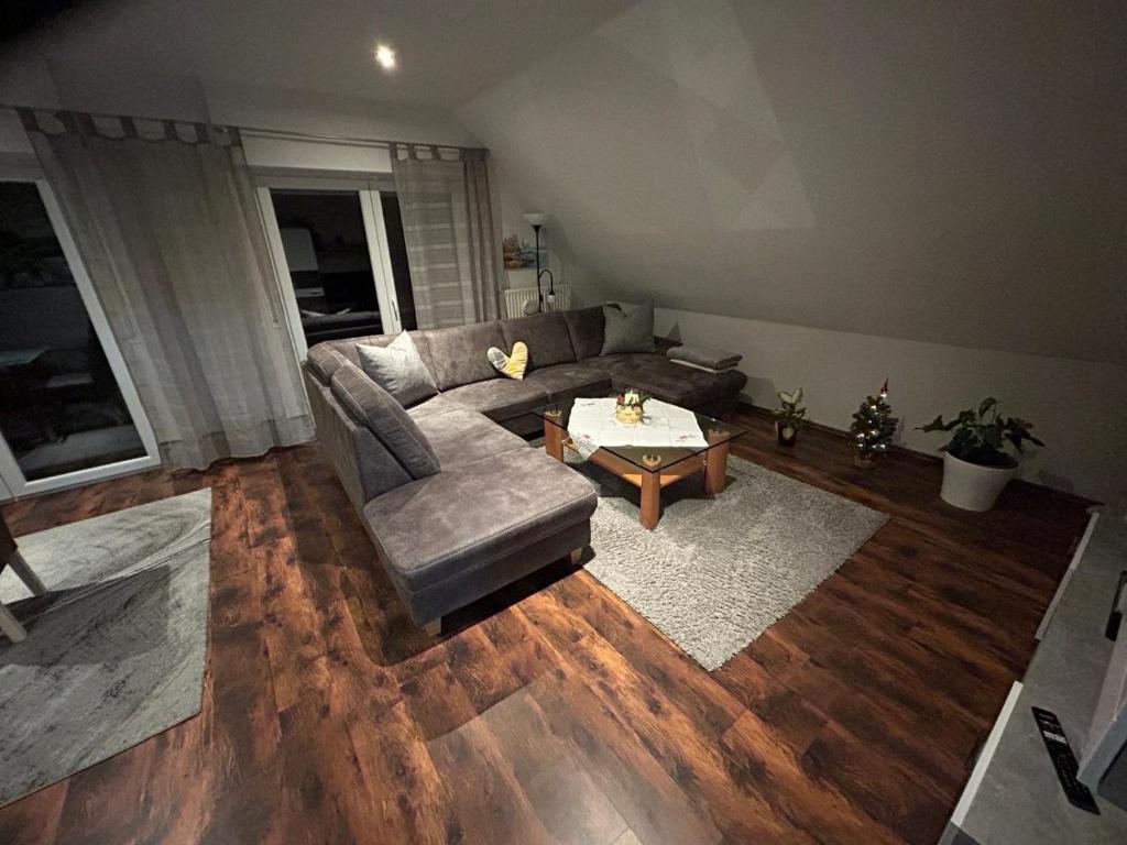 a living room with a couch and a table at Apartment Grieshop in Dinklage