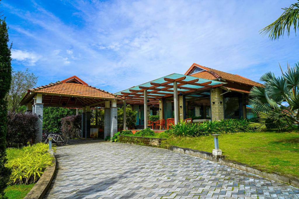 a house with a cobblestone road in front of it at Open Hotel by Olive - Biranji Aqua Reatreat in Chikmagalūr