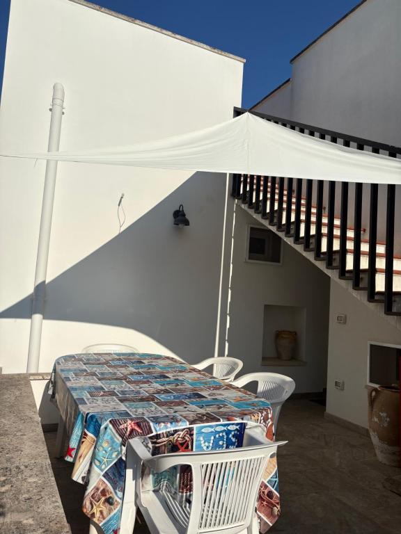 a table and chairs on a balcony with a white tent at tata Uccio in Matino