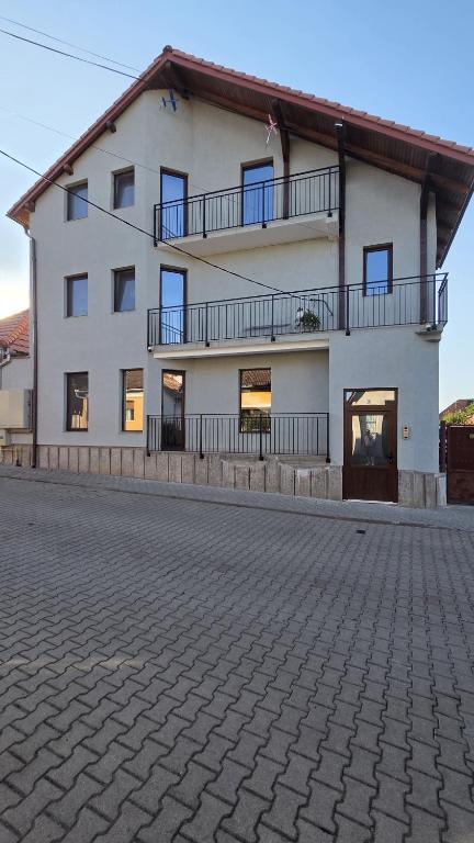 a large white building with a lot of windows at Complex Casa Morii in Orăştie