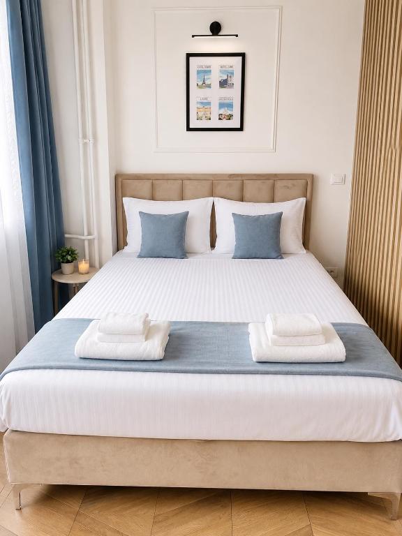 a bedroom with a large bed with two pillows at Fontana Lux Apartment in Belgrade
