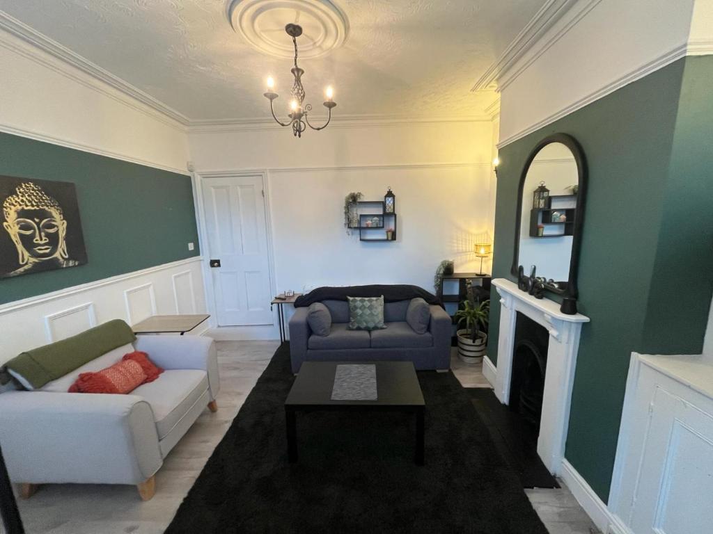 a living room with a couch and a chair at Sleeps up to 8 Free Parking Large Town House 3 Bed, 2 Bathrooms Private Locked Garden In-between Nottingham & Derby Contractor Friendly in Ilkeston