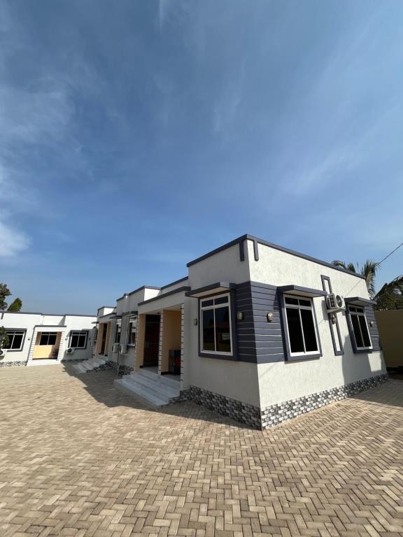a house on a brick driveway in front at Seneu Executive Residence in Mwanza