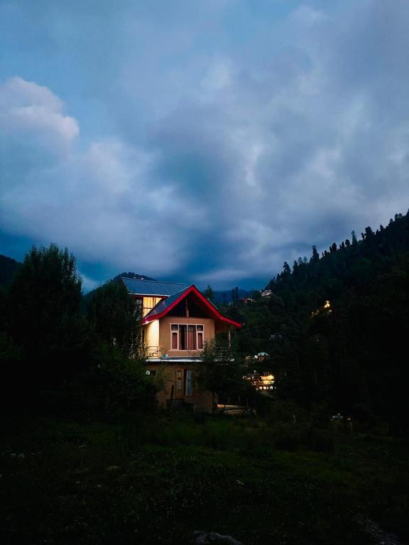 a house sitting on top of a hill at Flamingo Aur Maina Stays - Jibhi in Jibhi