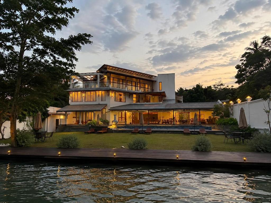 a large house on the side of a body of water at Aradhana by Nepali in Moratuwa