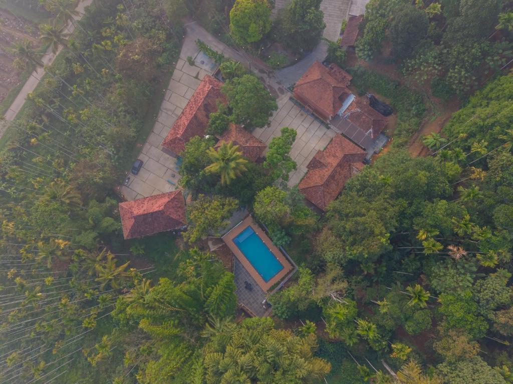 an overhead view of a house with a swimming pool at Swastha Royals Wayanad in Kaniyāmbetta
