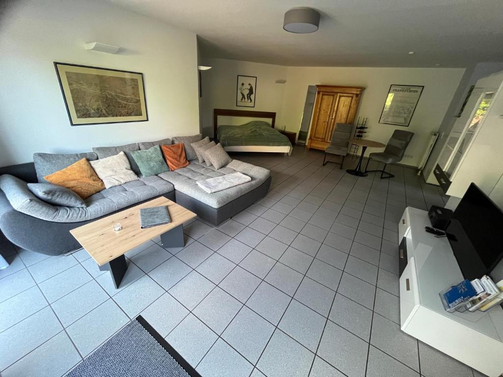 a living room with a couch and a table at Apartment Akazie in Weinsheim