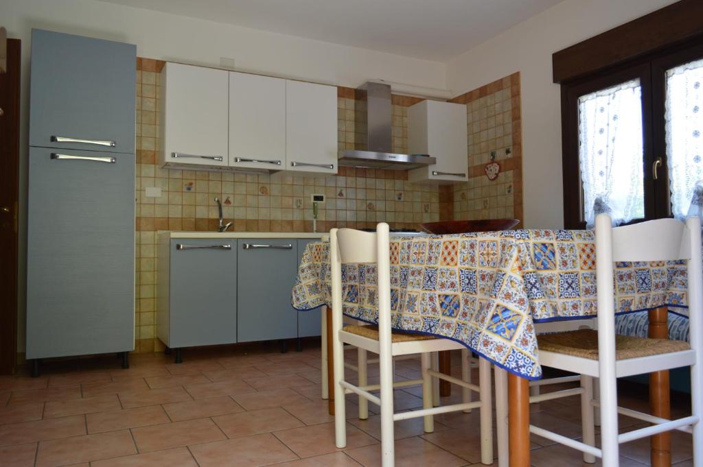 a kitchen with a table with a tablecloth on it at il nido in Capoterra