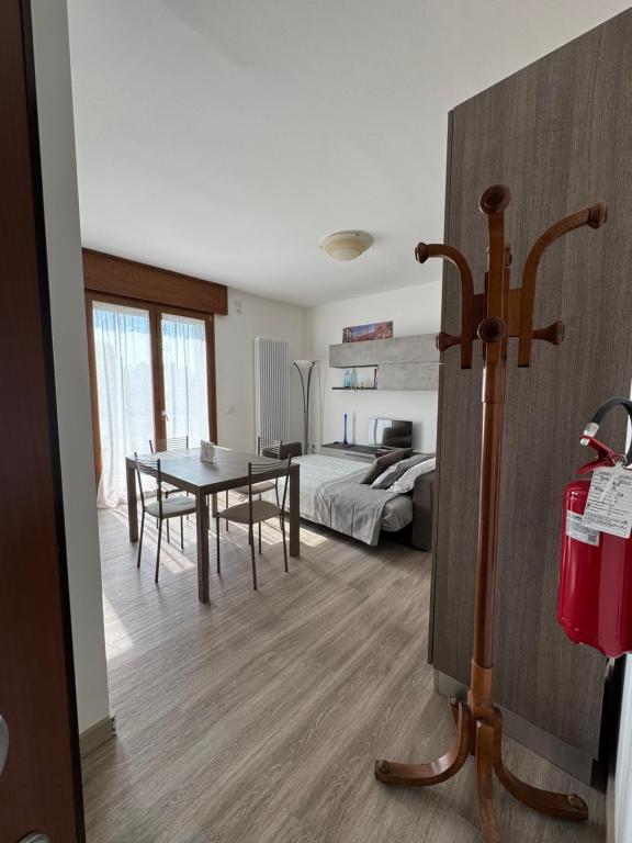 a living room with a table and a bedroom at Tarvisium Apartment in Treviso