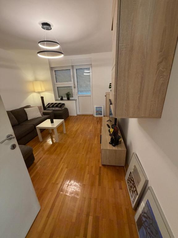 a living room with a couch and a table at DiSte Apartman in Knin
