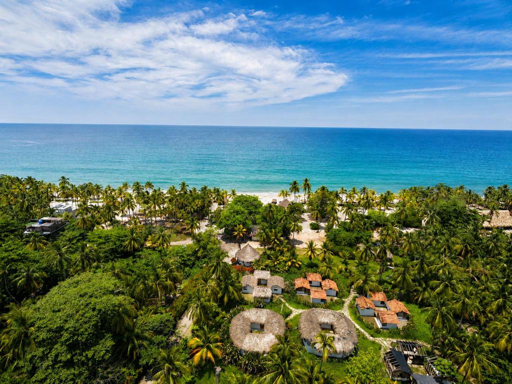 an aerial view of a resort near the ocean at Casa Grande Surf in Guachaca