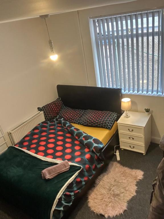 a bed in a room with a large window at Quiet room Nr2 in Coundon