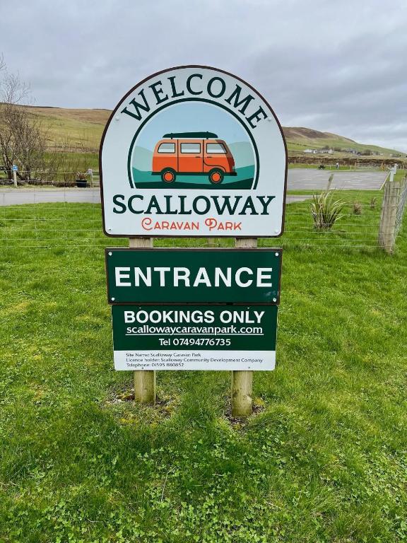 a sign for a secludedannisannis park with a car on it at Scalloway Caravan Park in Scalloway