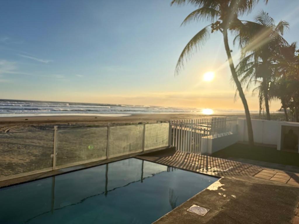 a view of the beach from a house with a swimming pool at Front Beach Beautiful house with pool & AC in Pochomil