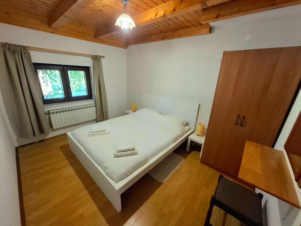 a small bedroom with a bed and a window at Zelena Dolina in Ćuić Brdo