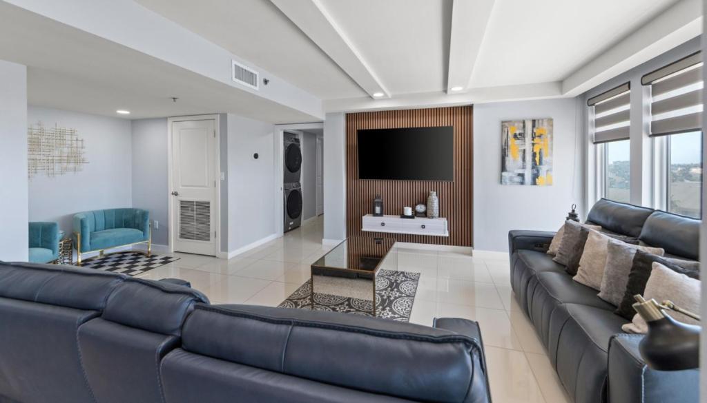 a living room with a couch and a tv at Solare Tower Sunset Panorama Paradise in South Padre Island