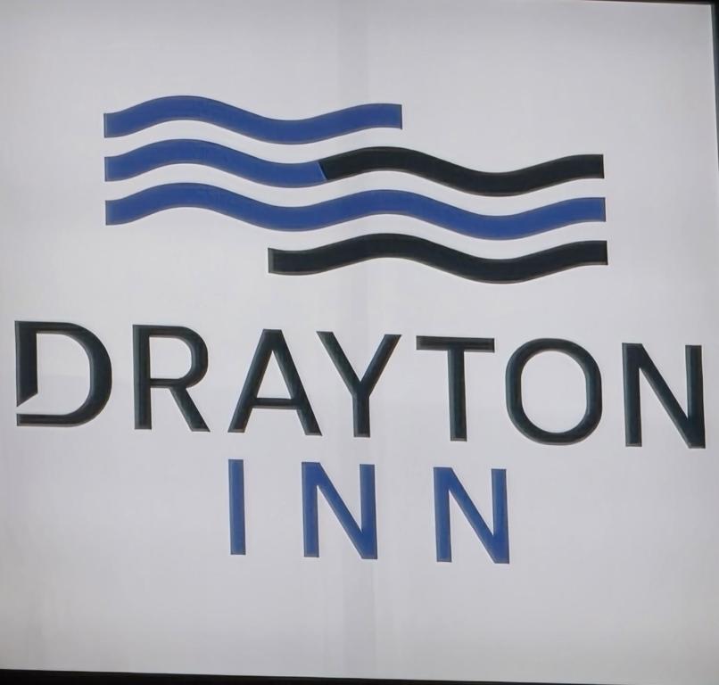 a sign for a car warranty inn at Drayton Inn in Drayton
