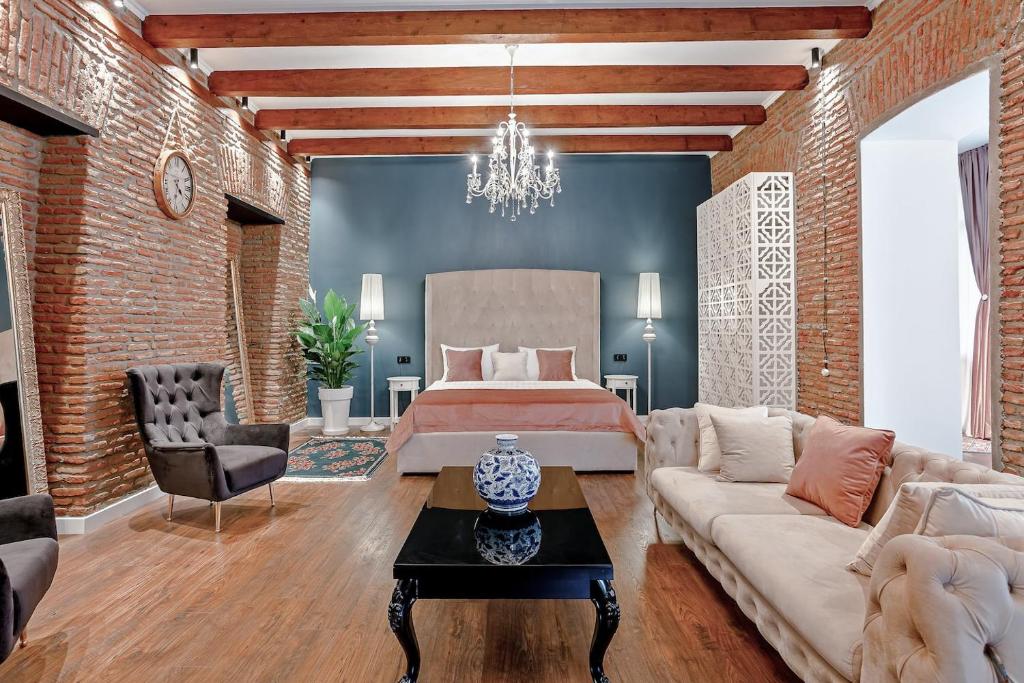 a living room with a bed and a couch at Eiffel Grand View in Paris