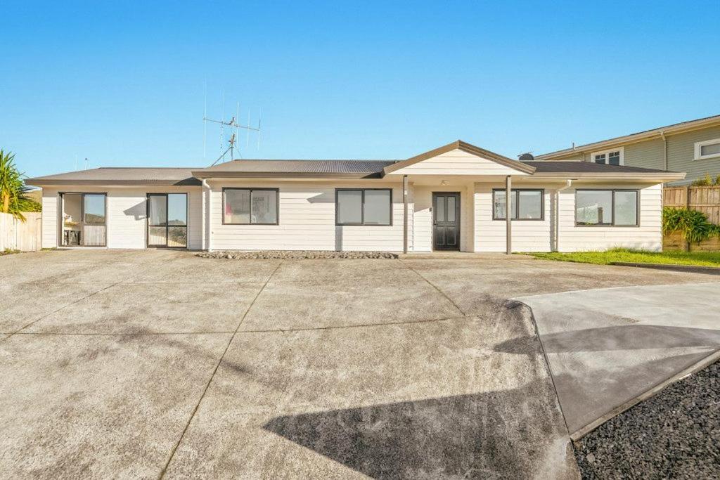 a house with a driveway in front of it at Welcome Bay Stay in Tauranga