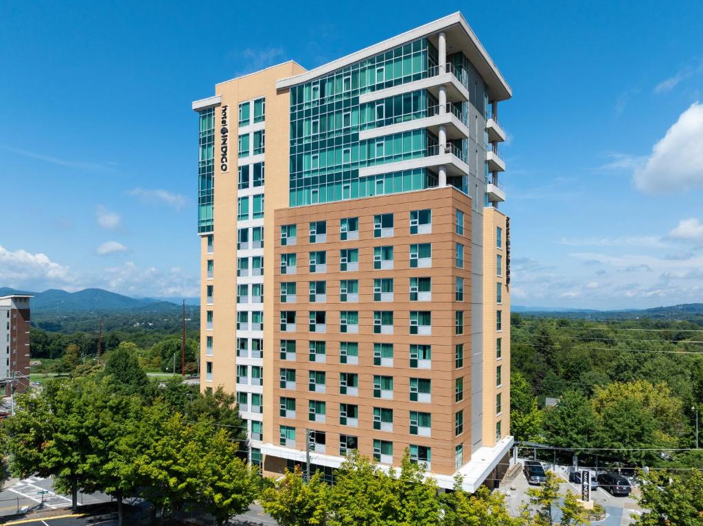 a tall building with a view of a city at Hotel Indigo Asheville Downtown by IHG in Asheville