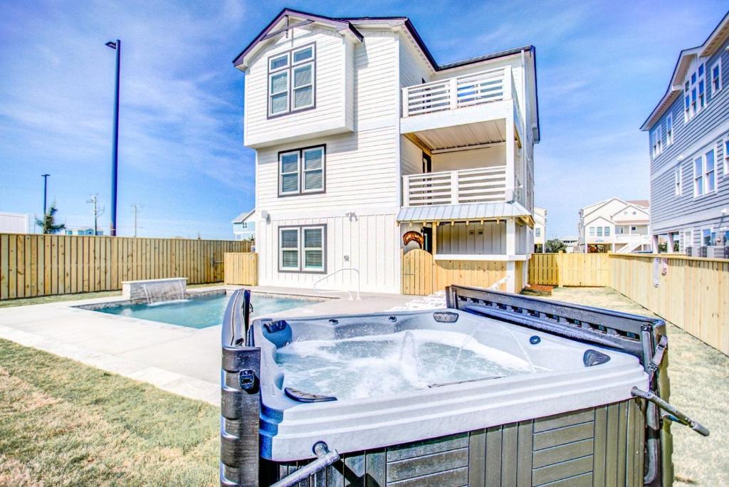 a hot tub in the backyard of a house at 4059 - Bikinis Martinis in Kitty Hawk
