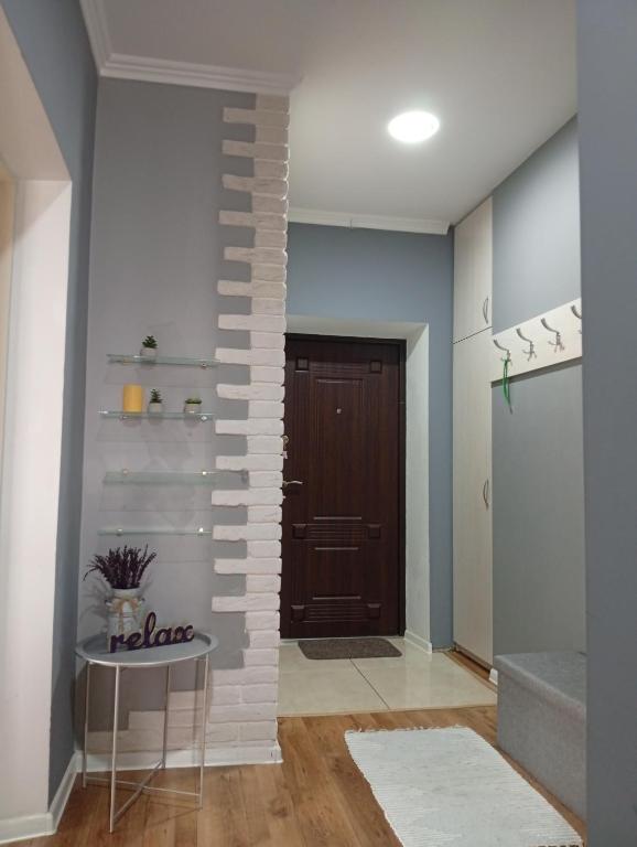 a hallway with a brick wall next to a door at Gray in Ternopil